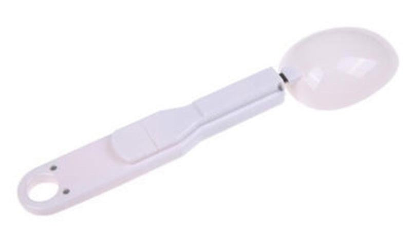 White measuring spoon on a white background