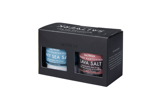 Two jars of sea salt in a black gift box on a white background
