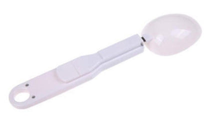 White measuring spoon on a white background